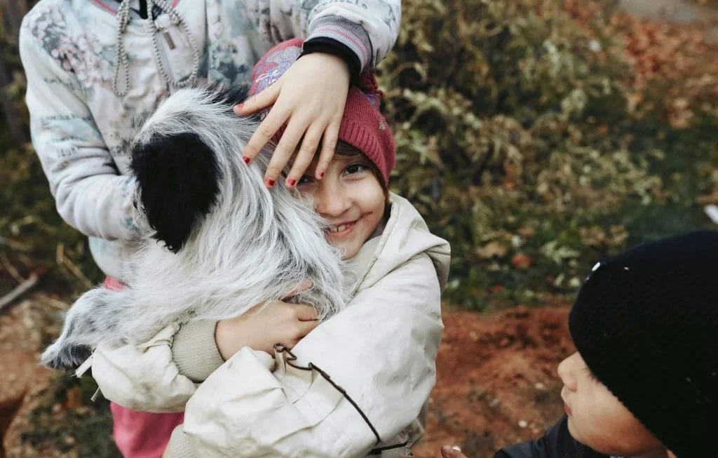 Children playing with pets in a safe and caring environment