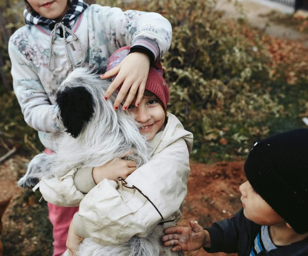 Children playing with pets in a safe and caring environment