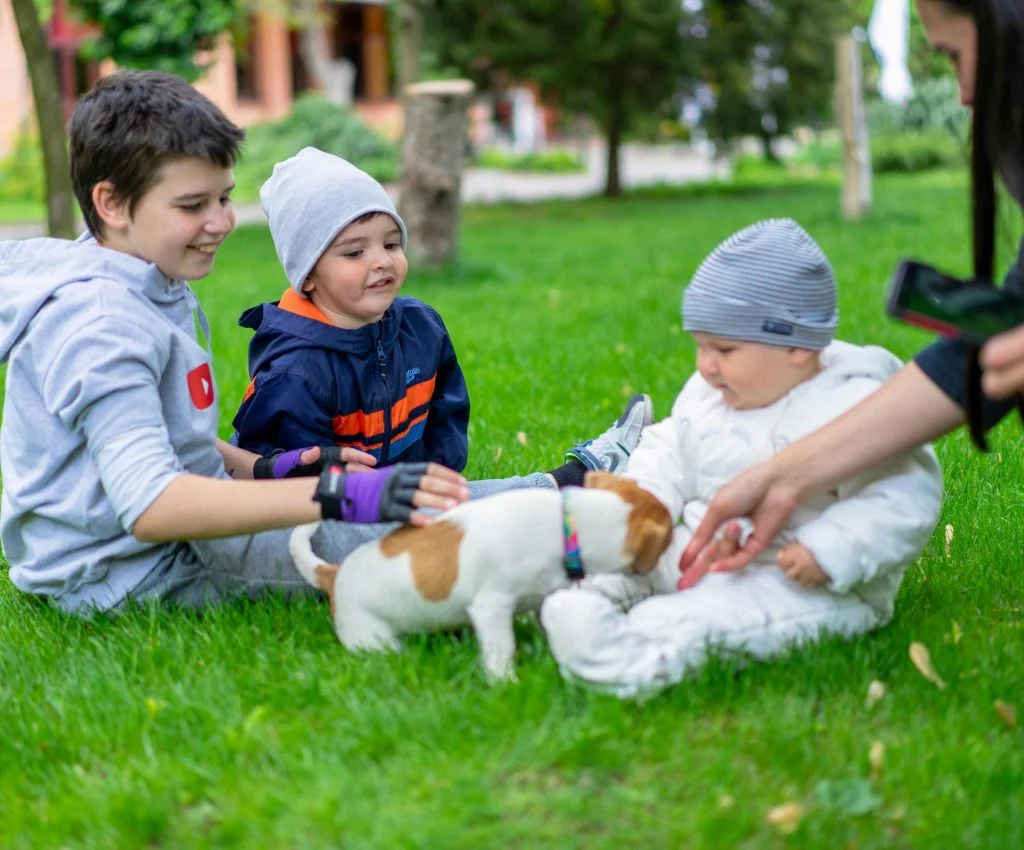 Children playing and caring for pets with adult supervision